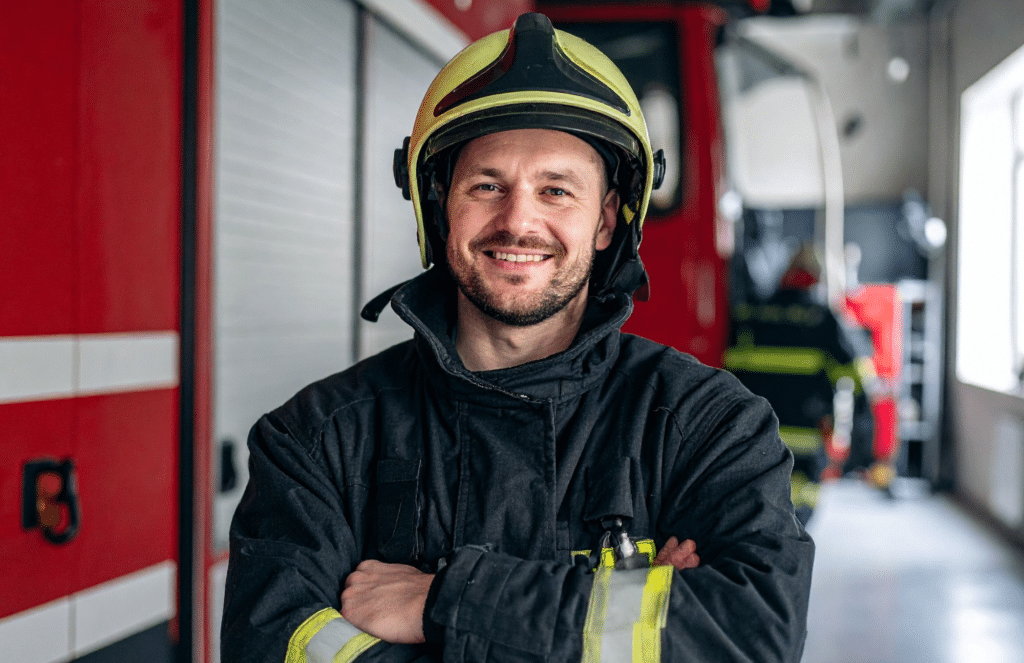 A confidnetly smiling firefighter in La Jolla, CA, at Smile More La Jolla. After dental treatment